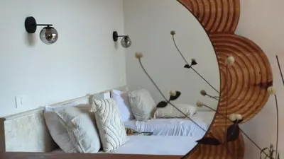 a mirror reflection of a couch in a room at Araya Resort in Las Galeras