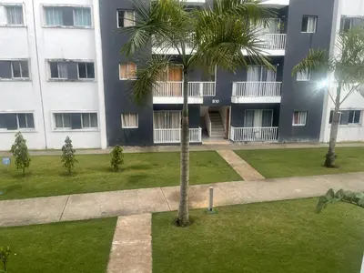 a palm tree in front of a building at Apartamento en Higuey City Home in Higuey