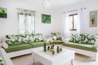a living room with green and white couches and a table at Villa Retreat in Ibiza, Punta Cana in Punta Cana