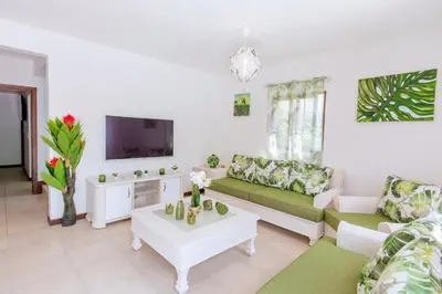 a living room with a couch and a table at Villa Retreat in Ibiza, Punta Cana in Punta Cana