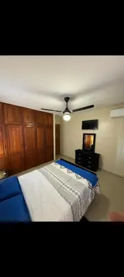 a bedroom with a large bed and a ceiling fan at Casa entrada el cachon lucerna in Cancino Adentro