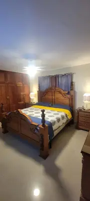 a bedroom with a large wooden bed and two dressers at Casa entrada el cachon lucerna in Cancino Adentro