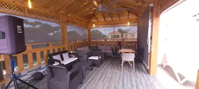 a screened in porch with chairs and a table at Casa entrada el cachon lucerna in Cancino Adentro