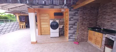 a washer and dryer in a kitchen in a house at Casa entrada el cachon lucerna in Cancino Adentro