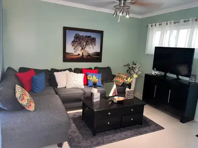a living room with a couch and a flat screen tv at Tranquilo Apartamento de 3 habitaciones in Los Paredones