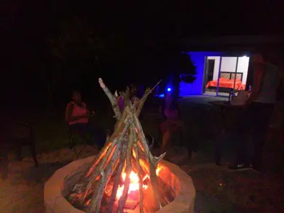 a group of people sitting around a fire at Villa Victoria in Sosúa