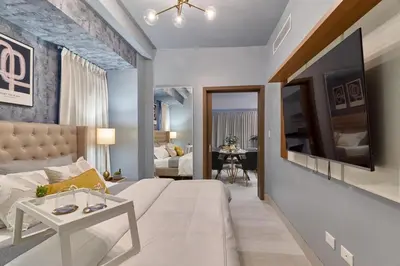 a living room with a large couch and a tv at Modern Comfort Apartment at Bella Vista in Santo Domingo