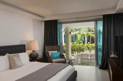 a bedroom with a bed and a view of a patio at The Ocean Club, a Luxury Collection Resort, Costa Norte in Sosúa