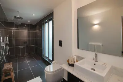a bathroom with a sink and a toilet and a mirror at The Ocean Club, a Luxury Collection Resort, Costa Norte in Sosúa