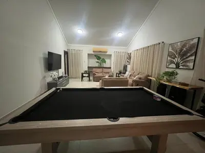 a living room with a pool table in a living room at Villa Guavaberry in Juan Dolio