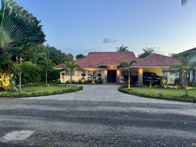 a house with a driveway in front of it at Villa Guavaberry in Juan Dolio