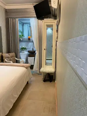 a bedroom with a bed and a room with a window at Feair in Santo Domingo