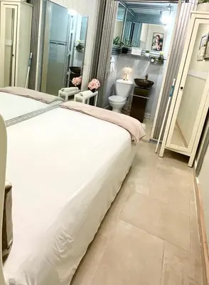 a bedroom with a bed and a bathroom with a toilet at Feair in Santo Domingo