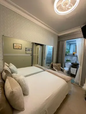 a bedroom with a large white bed in a room at Feair in Santo Domingo