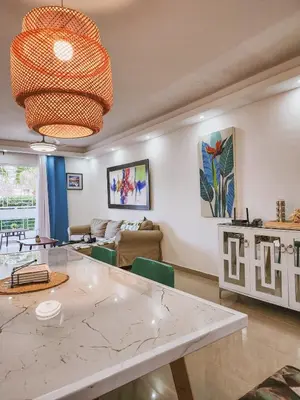 a kitchen and living room with a large marble table at Cozy apartment Marea Azul in La Francia