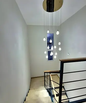 a room with a staircase and a chandelier at LD House Luxury Próximo embajada EEUU in Jacagua