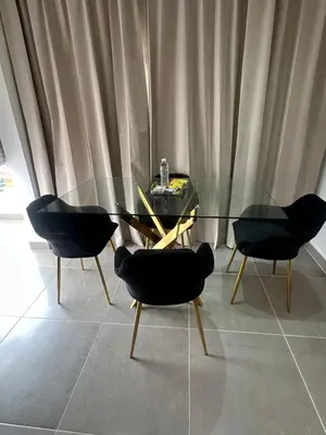 a dining room with a glass table and two chairs at Apartamento Santo Domingo este in Juan López