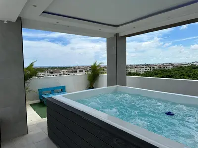 a hot tub on the roof of a house at Apartamento Santo Domingo este in Juan López