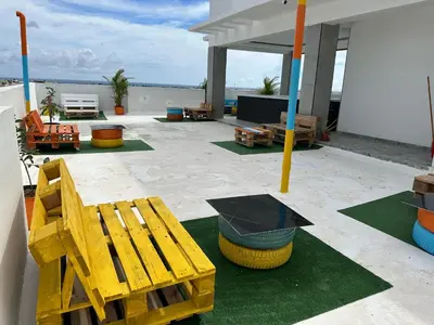 a patio with a wooden bench and a table at Apartamento Santo Domingo este in Juan López