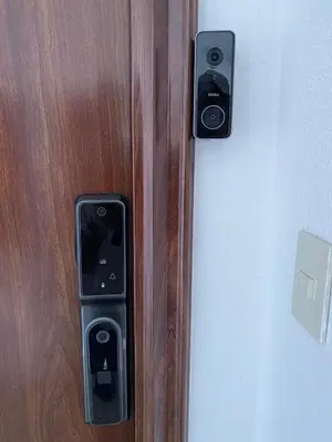 a wooden door with two security cameras on it at Cozy retreat with luxurious feel in Santiago de los Caballeros