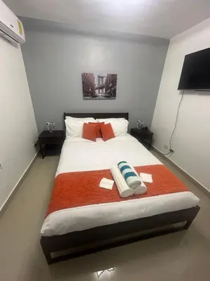 a bedroom with a large bed with towels on it at Cozy retreat with luxurious feel in Santiago de los Caballeros