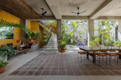 a patio with a table and chairs and plants at El Mambo Boutique Hotel in Las Terrenas