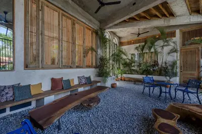 a living room with a couch and some plants at El Mambo Boutique Hotel in Las Terrenas