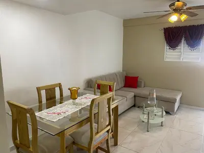 a living room with a table and a couch at Apartamento 2 Habitaciones BO in Santiago de los Caballeros