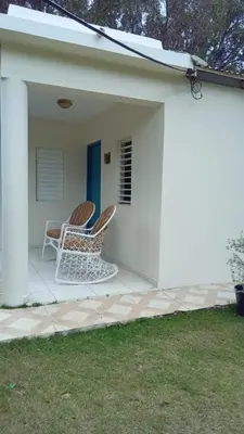 two chairs sitting on the porch of a white house at Nancy house in Monción