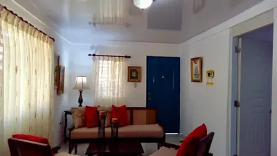 a living room with a couch and a blue door at Nancy house in Monción