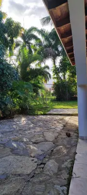 a porch of a house with palm trees in the background at MOREHomes - Caribe Slow Cost in Las Galeras