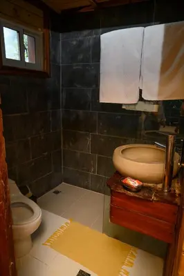 a bathroom with a toilet and a sink at villas ecologicas hacienda vista linda in Cabrera