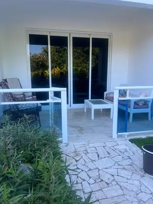 two benches sitting on a patio in front of a building at Laguna beach in Sosúa