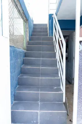 a set of stairs leading up to a building at Appartement cosy avec terrasse in Santa Bárbara de Samaná