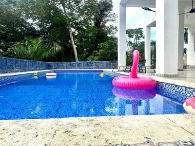 a swimming pool with a inflatable flamingo in the water at Double P Ranch 20 guests, BBQ and pool Buggy rental in Pedro Brand