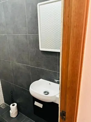 a bathroom with a white sink and a mirror at El Rincón Soleado 1 in San Felipe de Puerto Plata