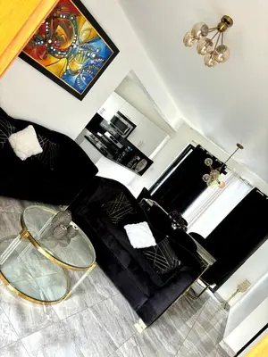 a living room with a black couch and a glass table at El Rincón Soleado 1 in San Felipe de Puerto Plata