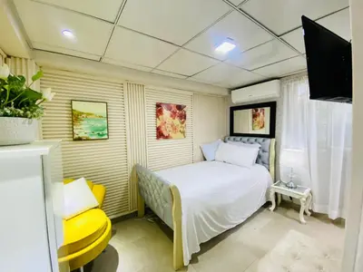 a bedroom with a bed and a tv in it at Jacqueline in Santo Domingo