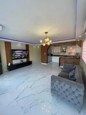 a large living room with a couch and a kitchen at Apartamento in Cancino