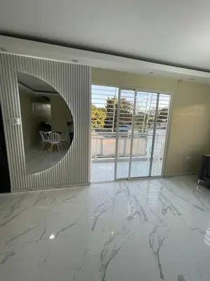 a living room with a marble floor and a large window at Apartamento in Cancino