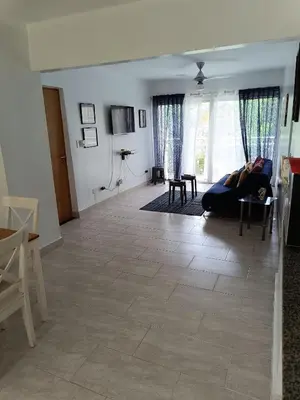 a person laying on a couch in a living room at Apartment in Riviera Colonial in Calero