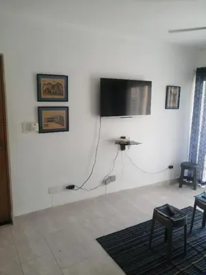 a white room with a flat screen tv on a wall at Apartment in Riviera Colonial in Calero