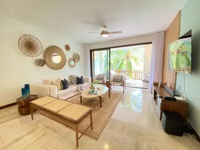 a living room with a couch and a tv at Charming two-bedroom apartment in Las Terrenas in Las Terrenas