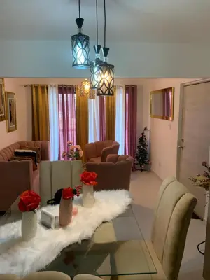 a living room with a table with flowers on it at Cómodo y acogedor in Los Paredones