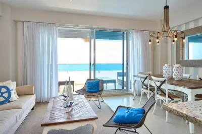 a living room with a couch and a table at Escape Beachfront Condos Las Olas Juan Dolio in La Puntica de Juan Dolio