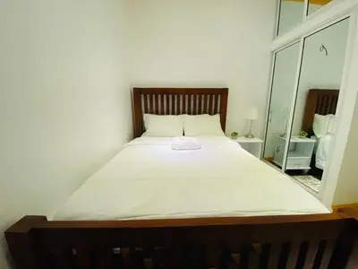 a large white bed in a room with a mirror at Colonial zone 3 bed 3 rooms balcony in Santo Domingo