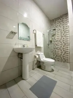 a white bathroom with a sink and a toilet at Colonial zone 3 bed 3 rooms balcony in Santo Domingo