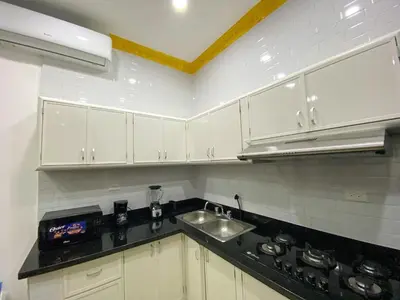 a kitchen with white cabinets and a sink at Colonial zone 3 bed 3 rooms balcony in Santo Domingo