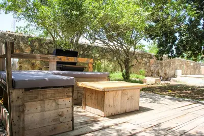 a bed and a table and a bench on a deck at Residencia Bambou HAVRE DE PAIX in Juan Dolio