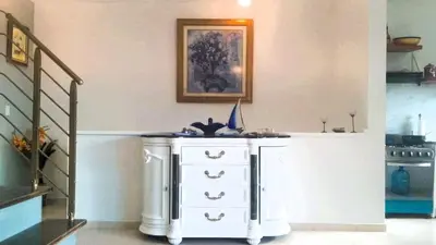 a white dresser in a room with a staircase at Apartment mit Meerblick direkt an der Playa Popy in Las Terrenas